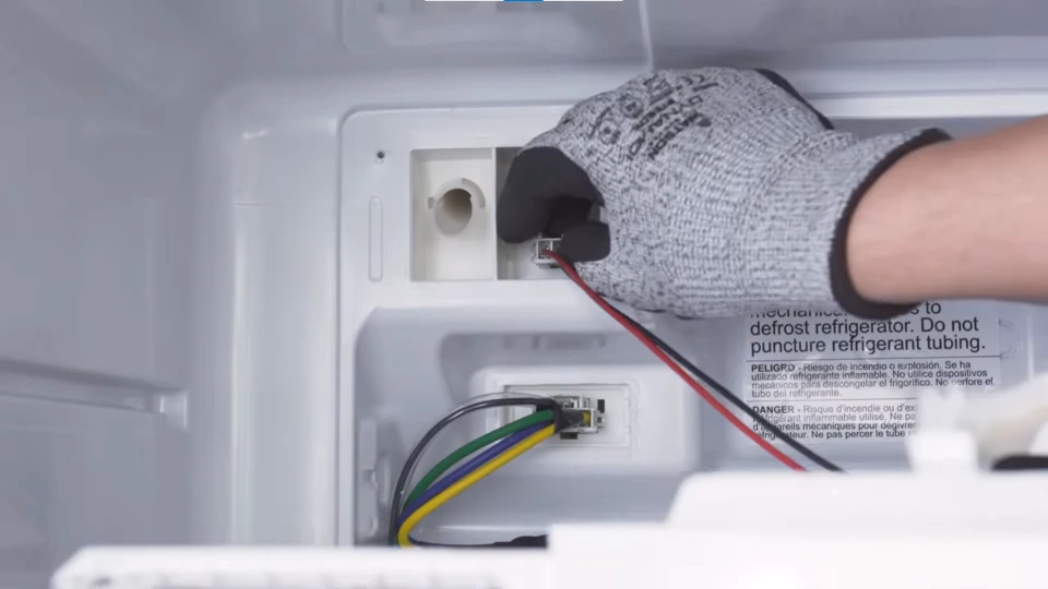 Refrigerator defrost heater wiring connector being replaced
